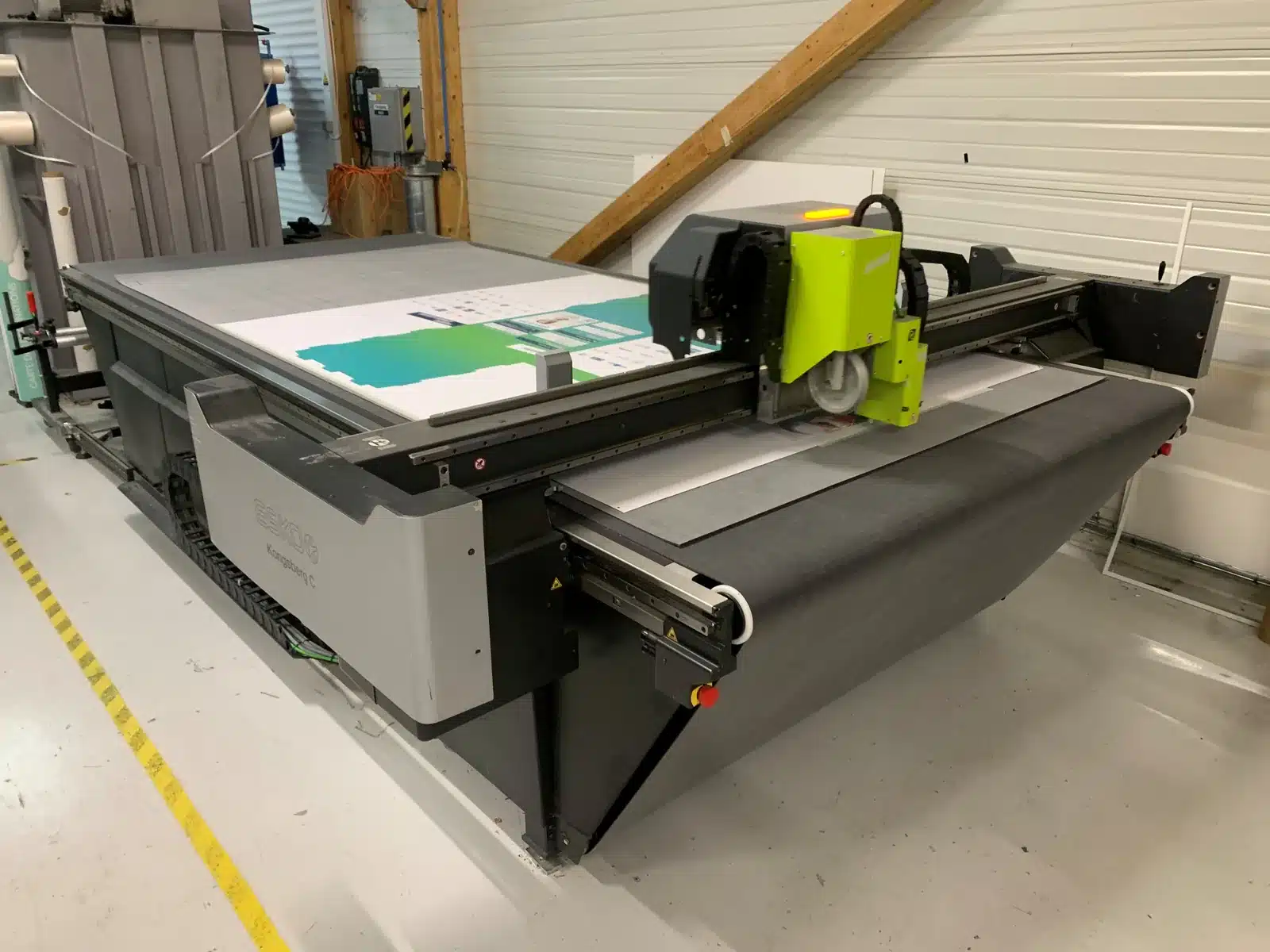 Table de découpe Kongsberg C24 d'occasion (2018) avec convoyeur et support de rouleau — vue globale